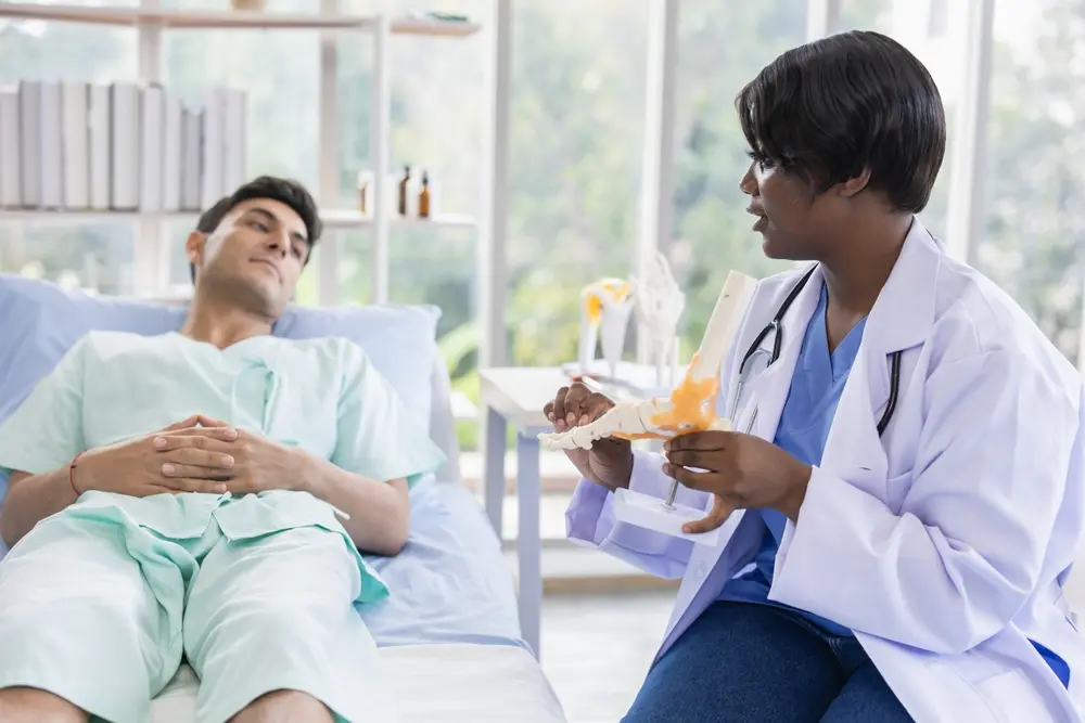 Female doctor assessing a male athlete for athletic clearance and sports participation