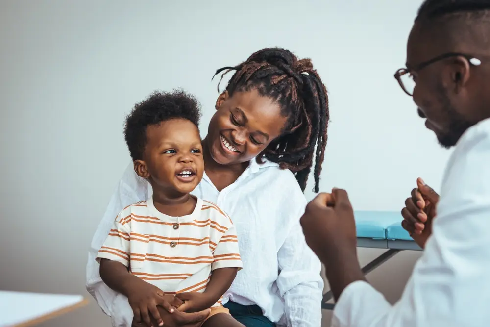 Female doctor speaking with a male patient about family health services