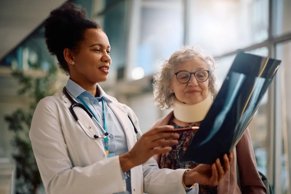 Female doctor reviewing Form I-693 with a male patient