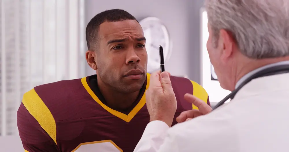 Provider checking vital signs and heart health during a sports physical at HelloCare Medical Group