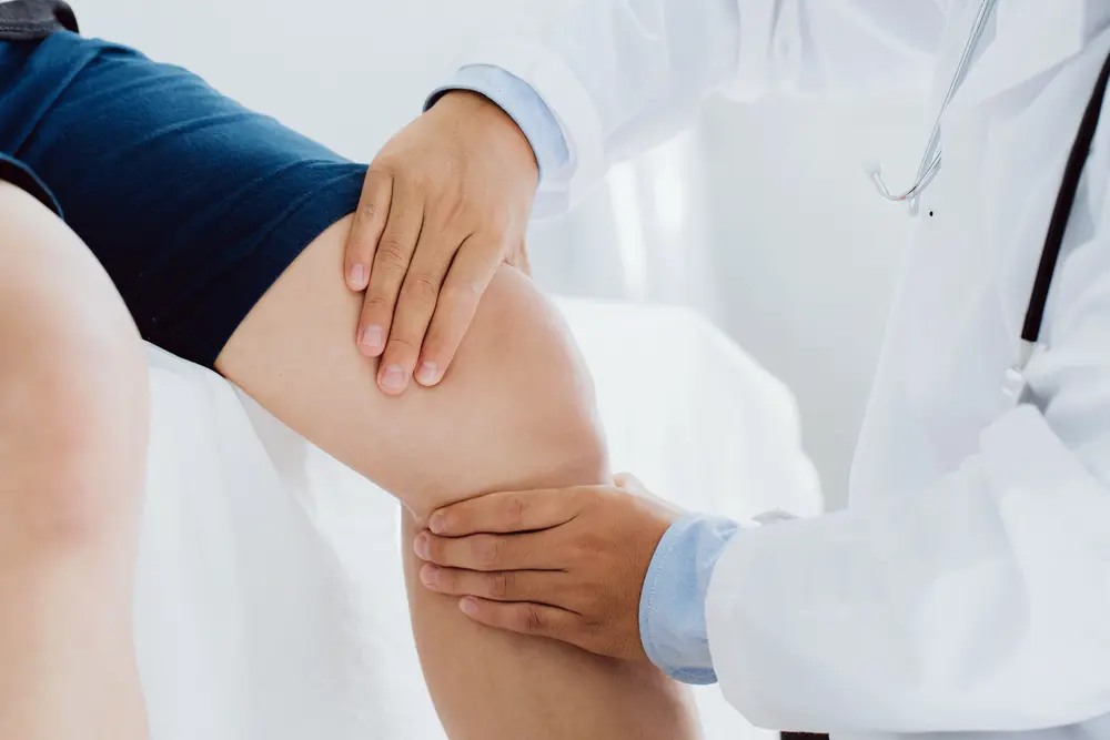 Doctor performing an athletic physical exam on a young athlete at HelloCare Medical Group in Royal Palm Beach, FL