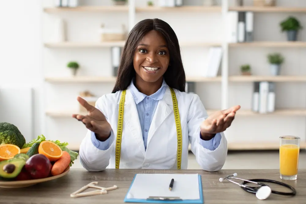 Smiling female doctor representing medical weight management in South Florida