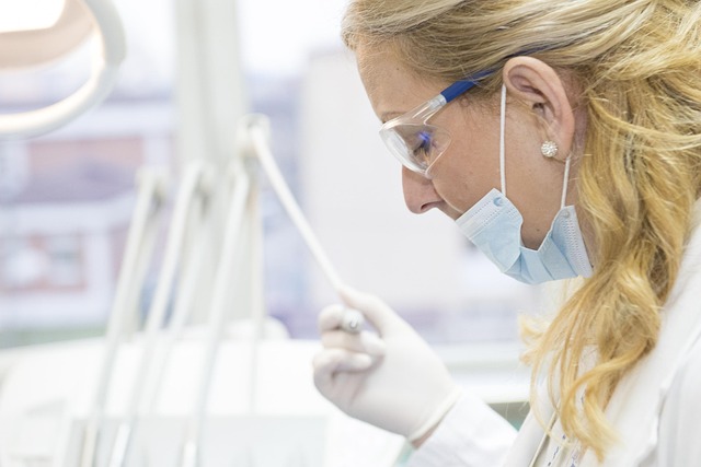 Masked female doctor with safety glasses conducting senior health screening research in a laboratory