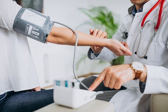 Male doctor checking a patient’s blood pressure during Suboxone care