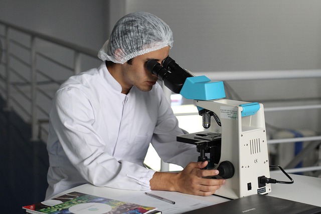 Person using a microscope for urgent medical evaluation in Palm Beach County