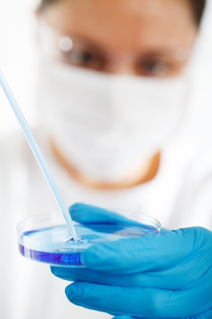 Gloved hand holding a laboratory container with liquid for weight loss treatment