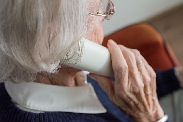 Elderly woman using a phone for senior health care