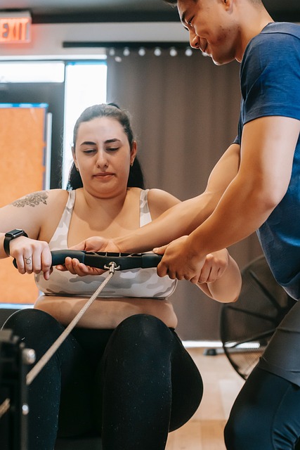Woman exercising with assistance for hormonal weight management